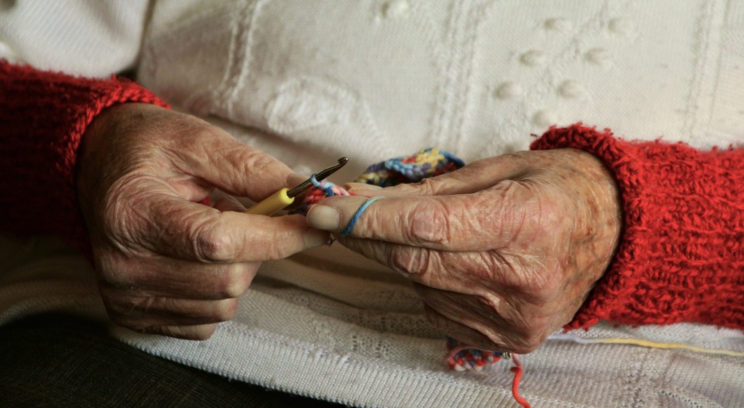 Elderly person's hands knitting