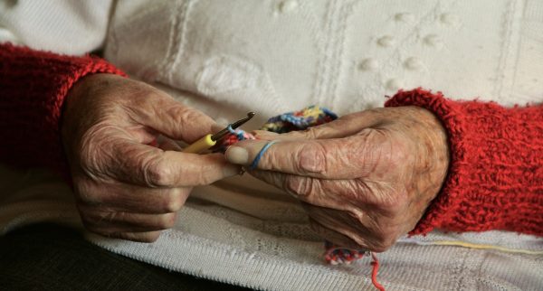 Elderly person's hands knitting