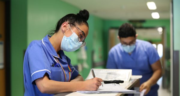 Stock image of staff on a busy ward