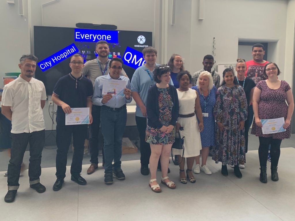 A group of people graduating from the programme