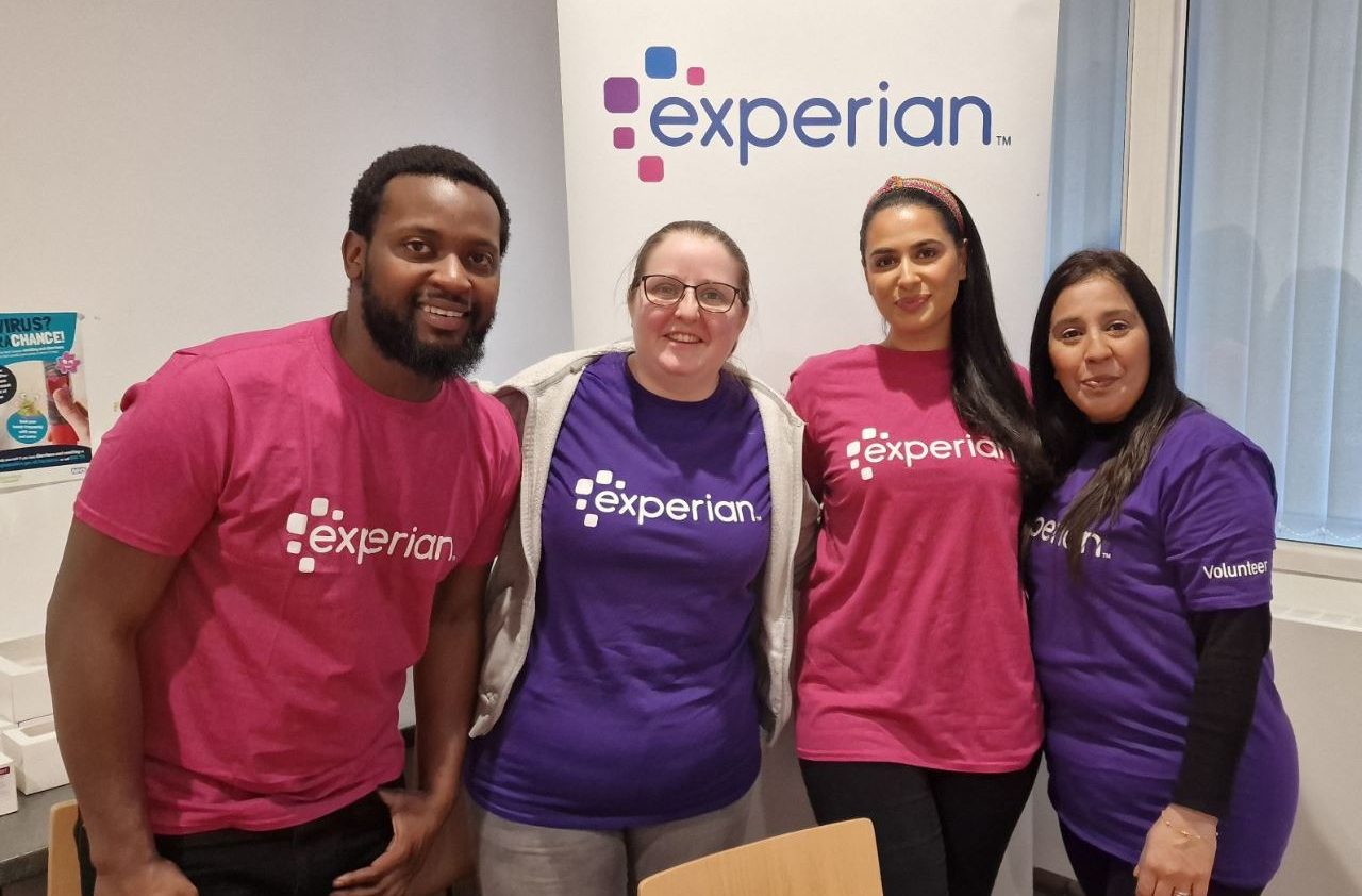 Staff from Experian are smiling at the camera and wearing Experian t-shirts