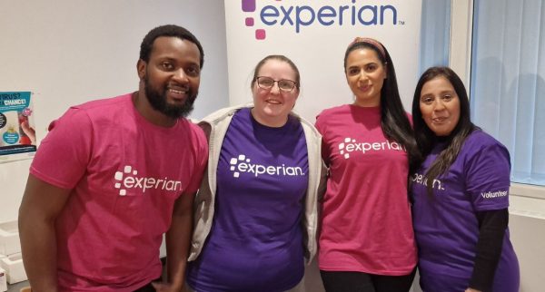 Staff from Experian are smiling at the camera and wearing Experian t-shirts