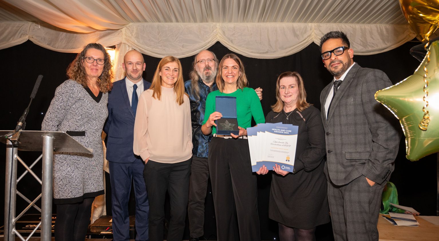 Picture shows team members celebrating award