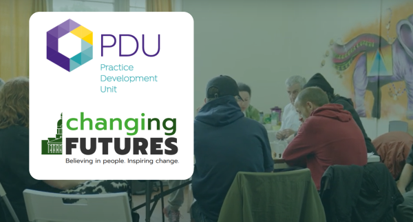 Image shows people round a table at Changing Futures event